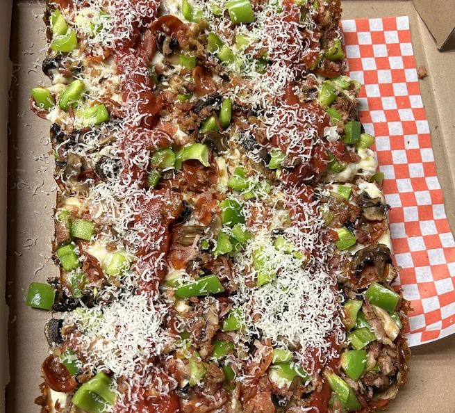 Detroit-style pizza loaded with pepperoni, mushrooms, green peppers and parmesan