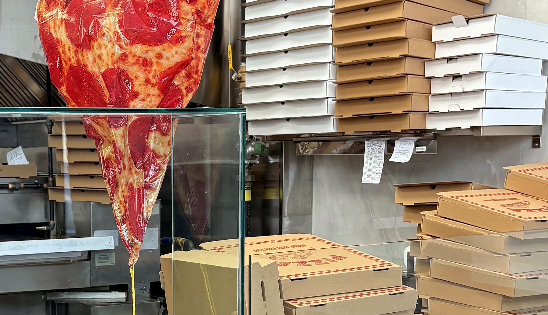 Original Pizza counter with its giant pizza slice sign