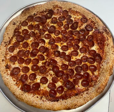 Round pizza covered in crispy roni cup pepperoni